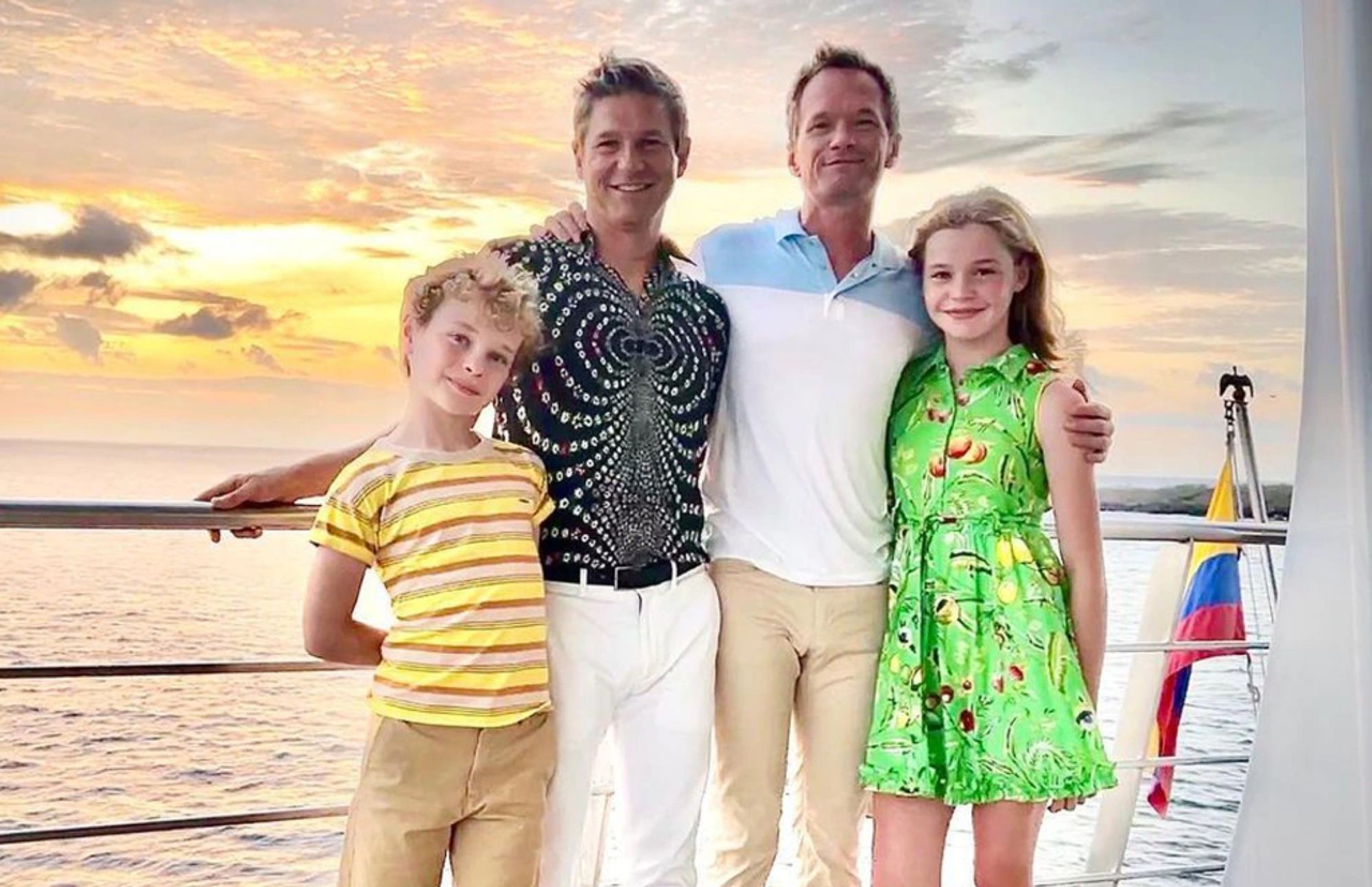 The water is seen in the background as Niel Patrick Harris and her husband David Burtkafa smile for the camera with their surrogate children
