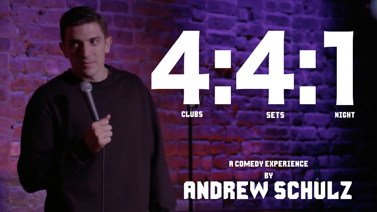 Andrew Schulz holding mic in the cover photo of his 4:4:1