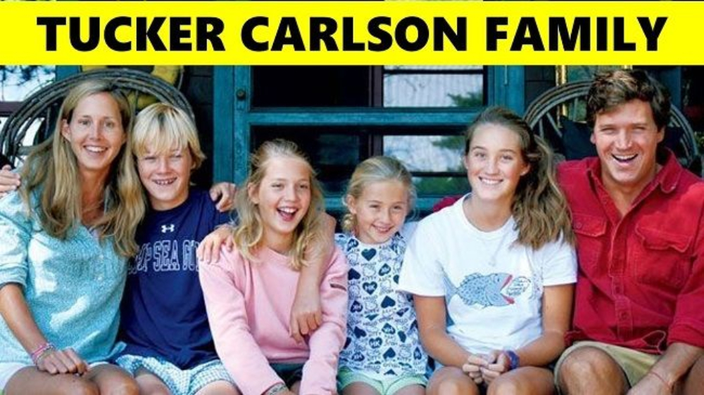 Tucker Carlson happily smiling with his wife and 4 kids 