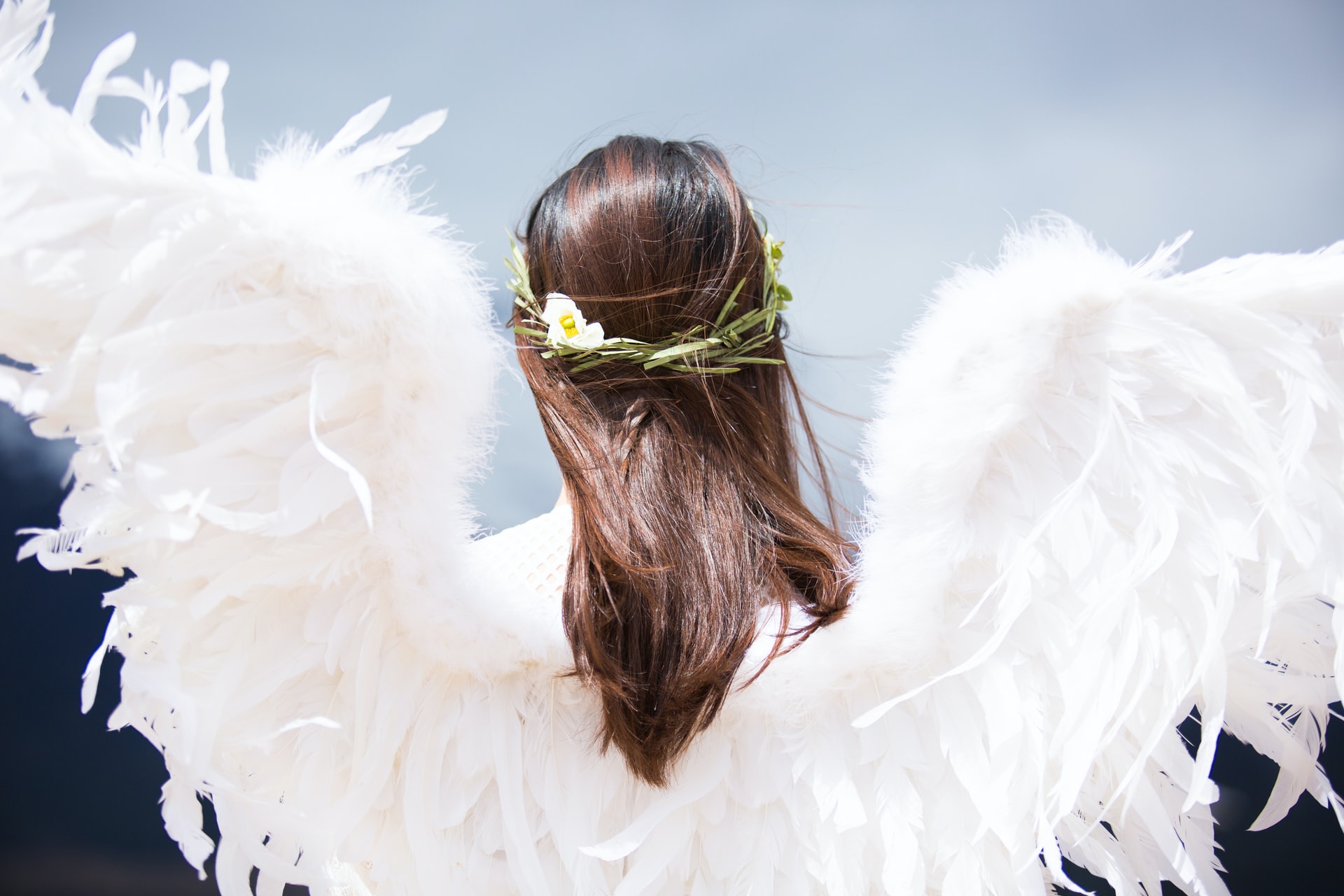 A Woman Wearing White Angel Wings