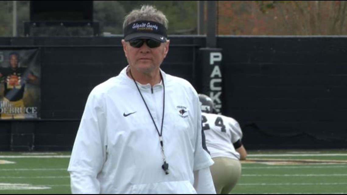 Rush Propst wearing a hat, white shirt, and a whistle on his neck