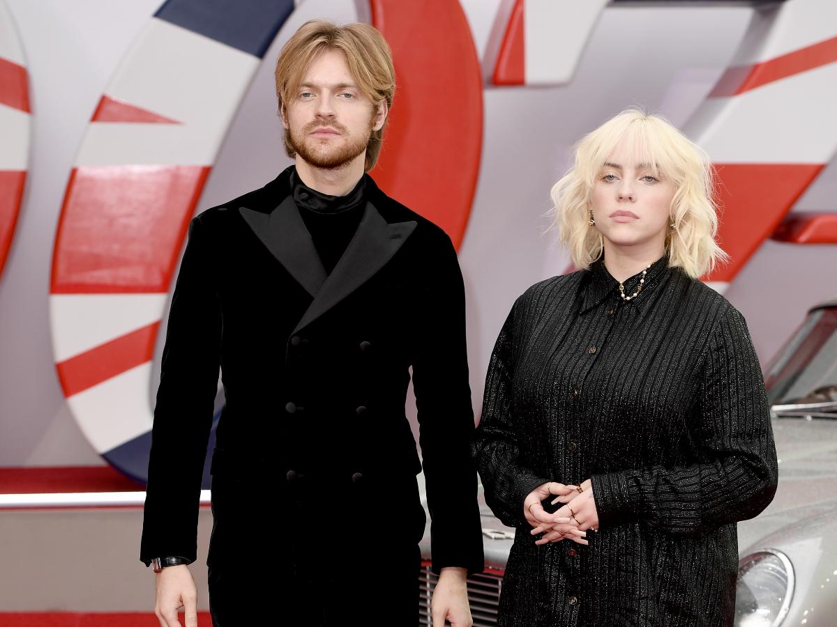 Billie Eilish and Finneas at an award show wearing black color dress