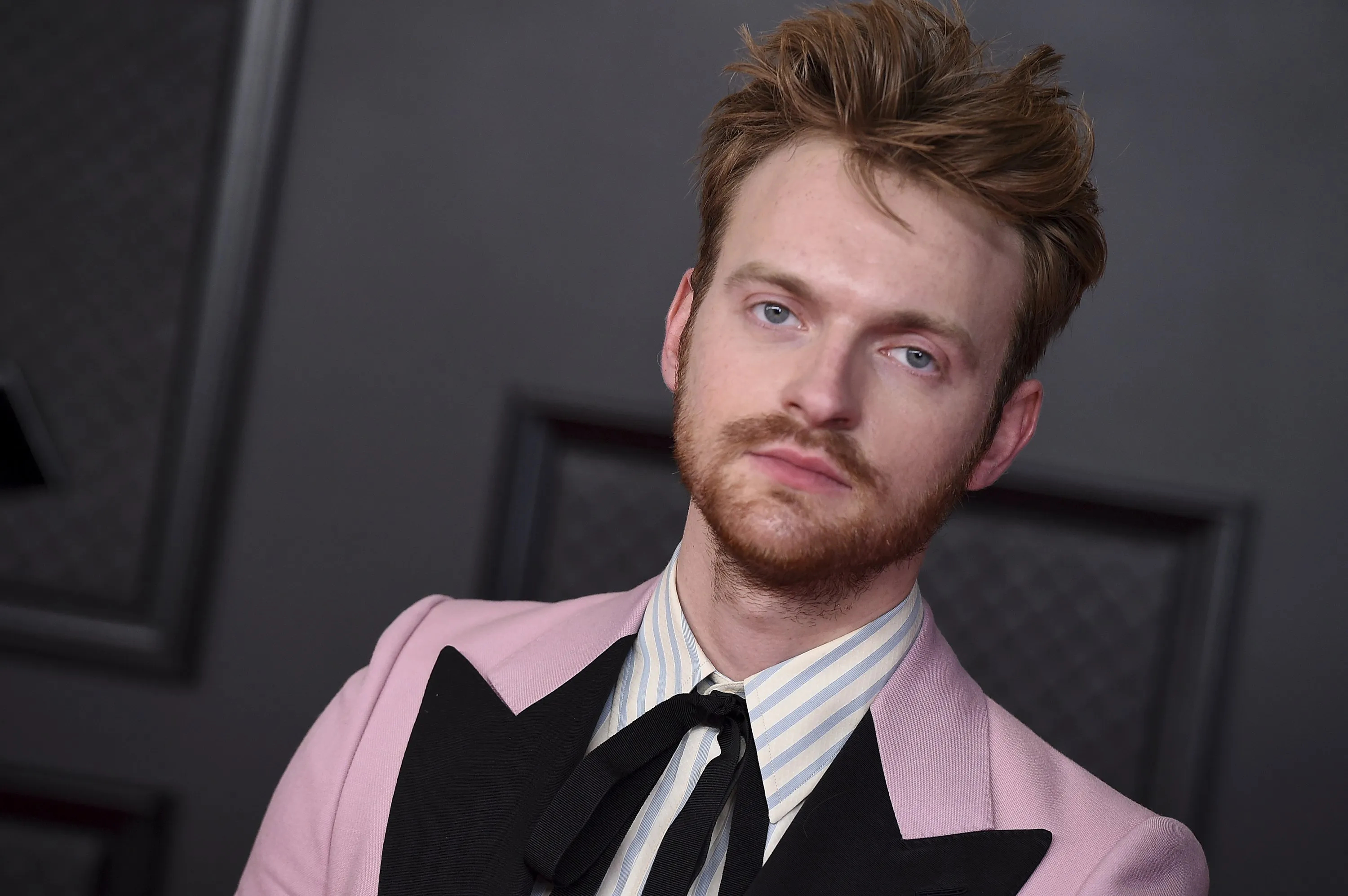 Finneas O'Connell wearing a pink and black suit