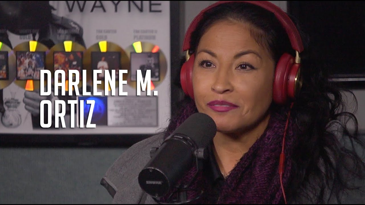 Darlene Ortiz wearing a red headphone and microphone in front of her