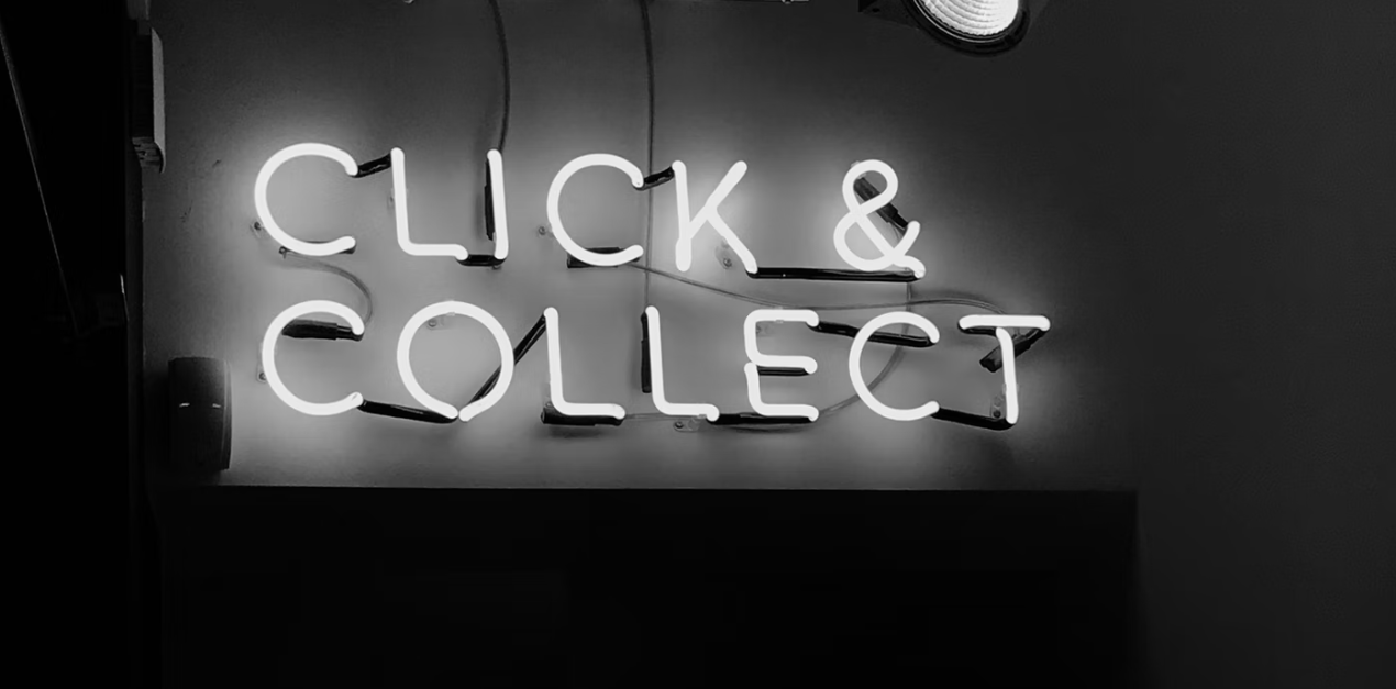 A neon light sign that says ‘click and collect’ in Carnaby Street in London