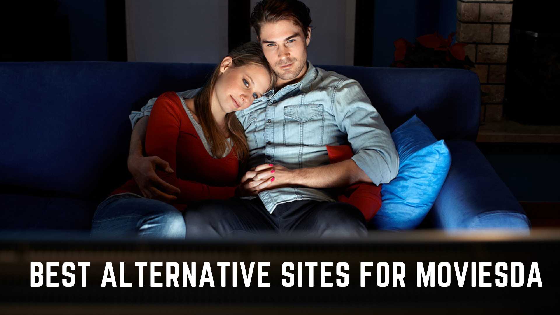 A couple sitting on a couch while watching TV with words Best Alternative Sites For Moviesda