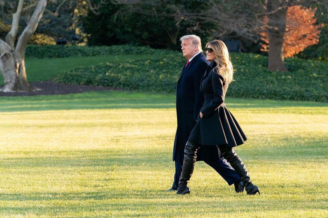 Donald Trump and Melania Trump walk together across the White House lawn