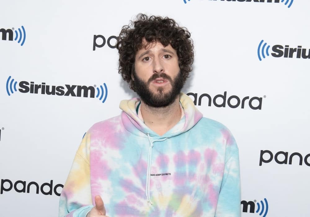 Lil Dicky wearing a pastel colored jacket