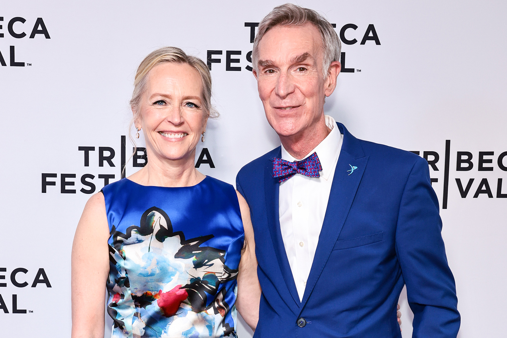 Bill Nye and Journalist and best-selling author Liza Mundy both smiling and wearing matching blue clothes