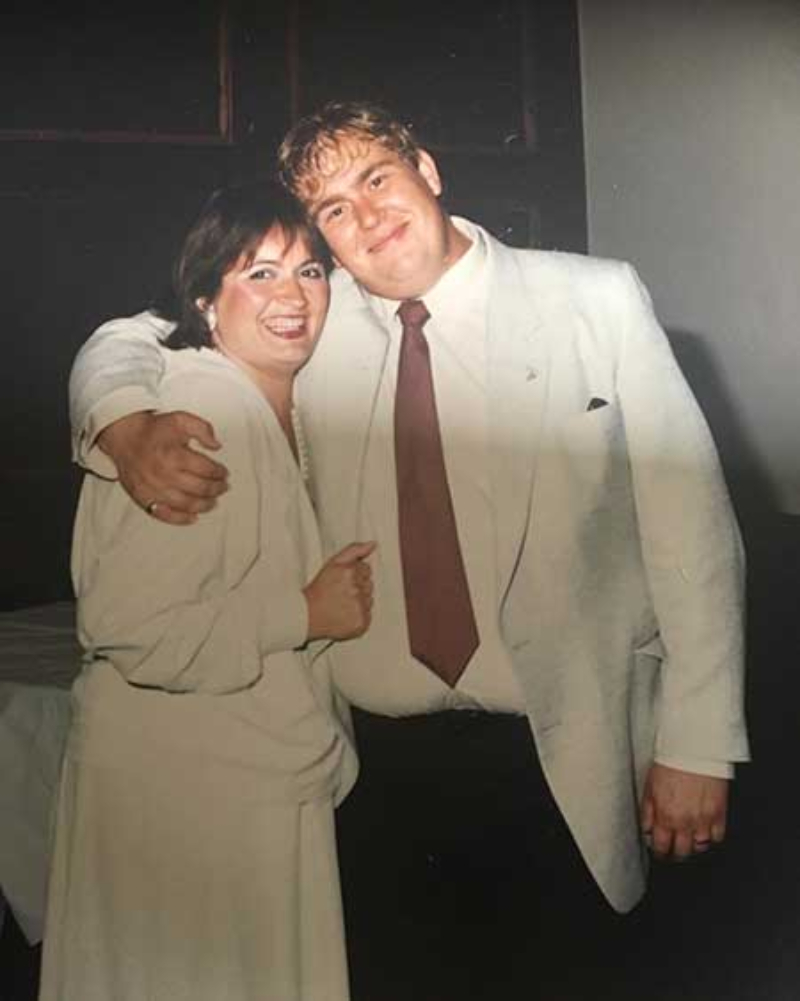 Rosemary and John Candy wearing white outfits and smiling
