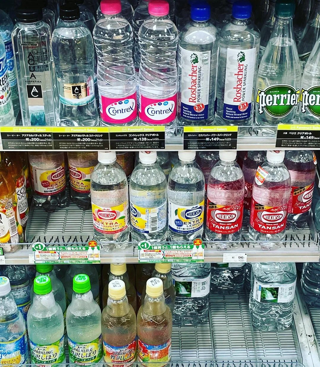 Assorted bottled waters including Contrex and Perrier in a Japanese grocery store