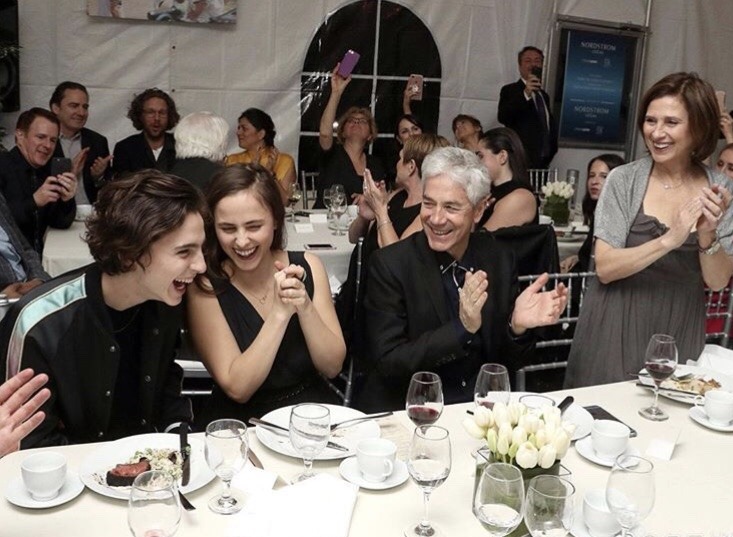 Marc Chalamet, Nicole Flender, and Pauline laughing and clapping while looking at Timothee Chalamet