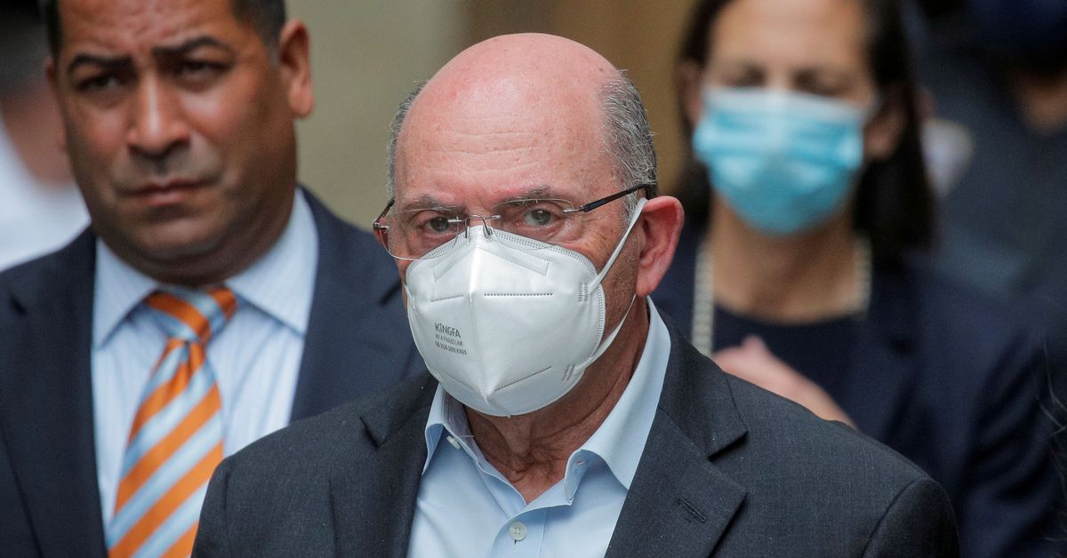 Ex-CFO wearing glasses and a white mask