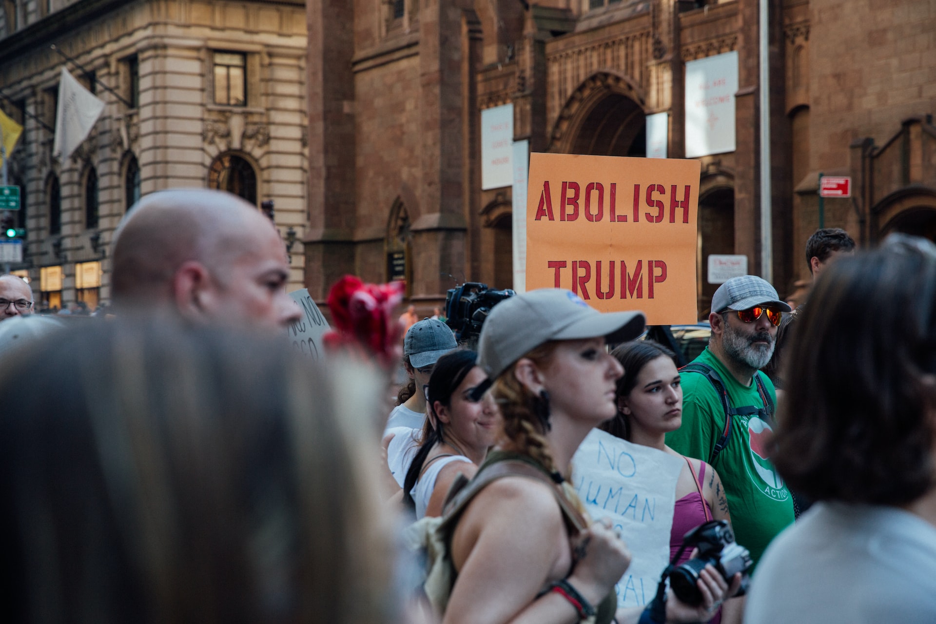 A crowd protesting Donald Trump in New York, with one carrying a sign that says ‘Abolish Trump’