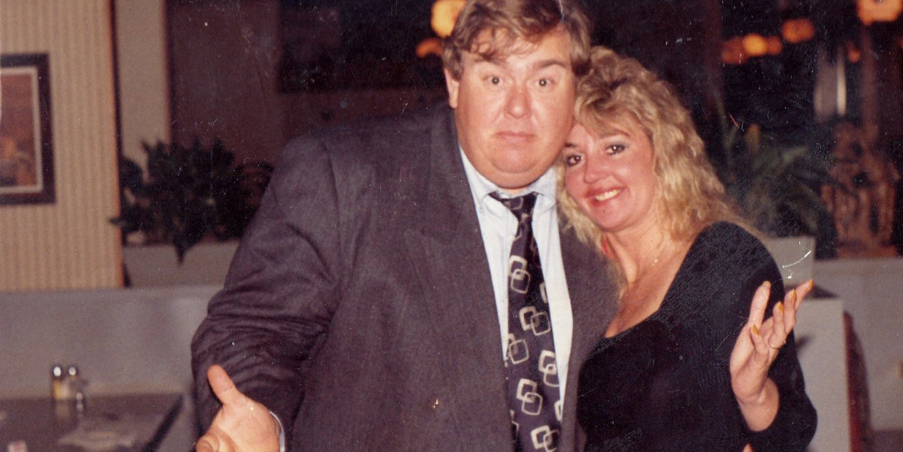 John Candy with his wife wearing a suit