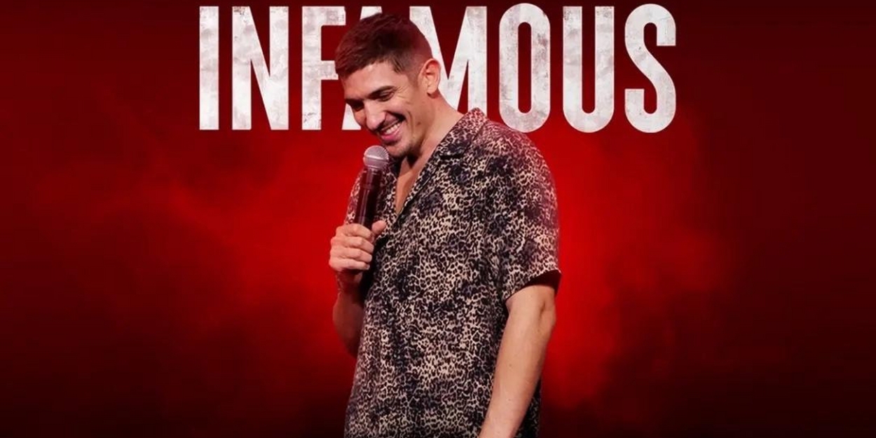 Andrew Schulz smiling while holding mic for cover photo of Infamous