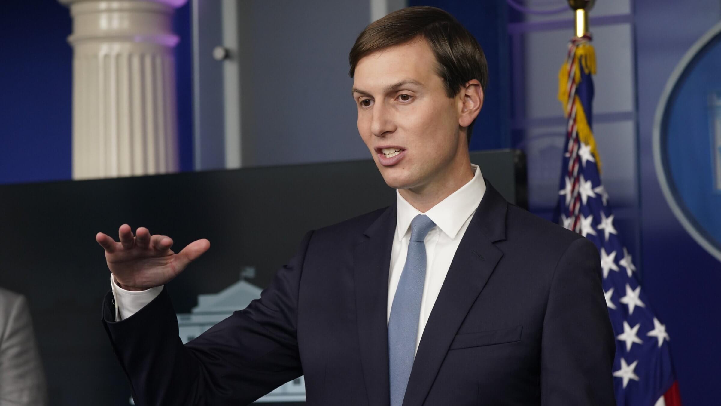 During the press conference, Jared Kushner is making statements while raising his right hand