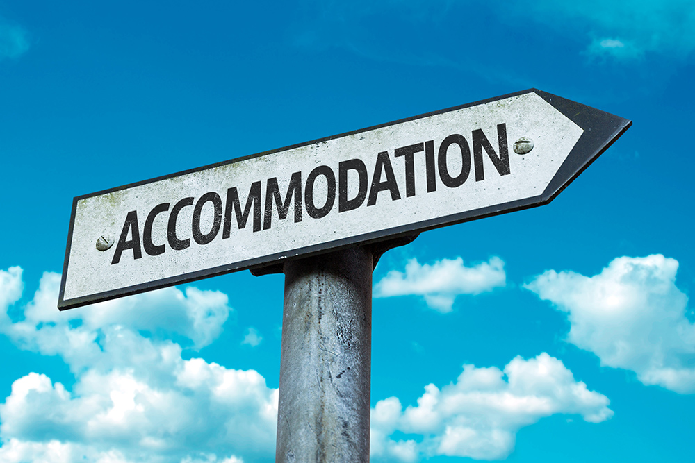 A road sign with the word Accomodation in it