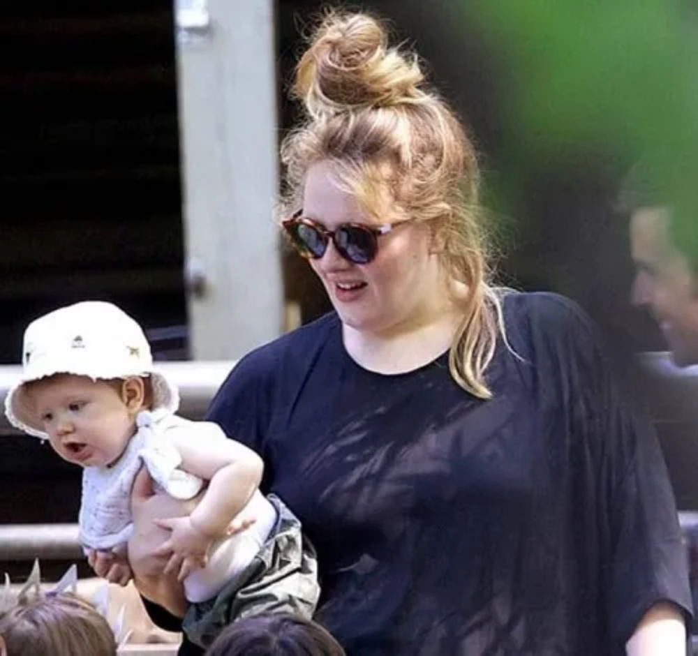Adele carrying toddler Angelo Adkins