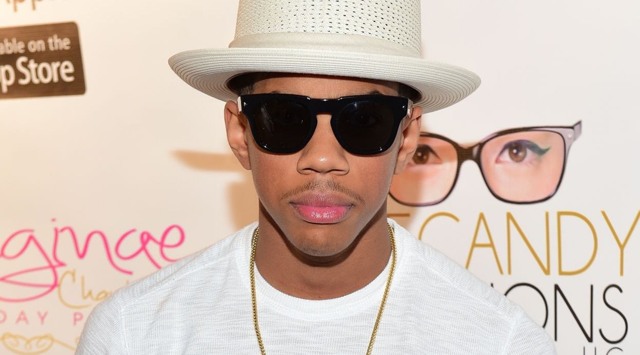 Wynton Harvey wearing a white t-shirt and off-white hat