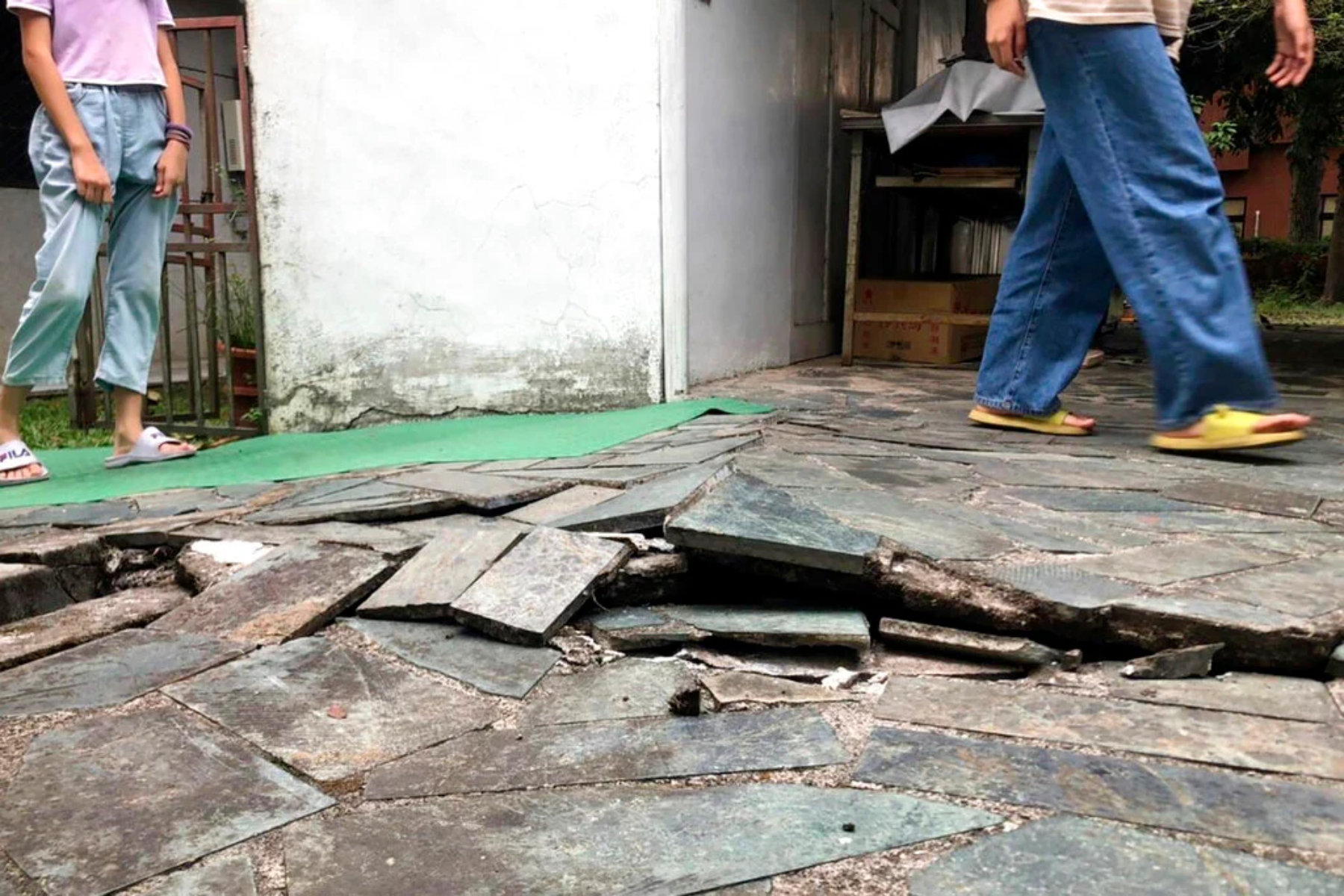 Cracks in the floor after a powerful earthquake in Taiwan, with two people walking beside it
