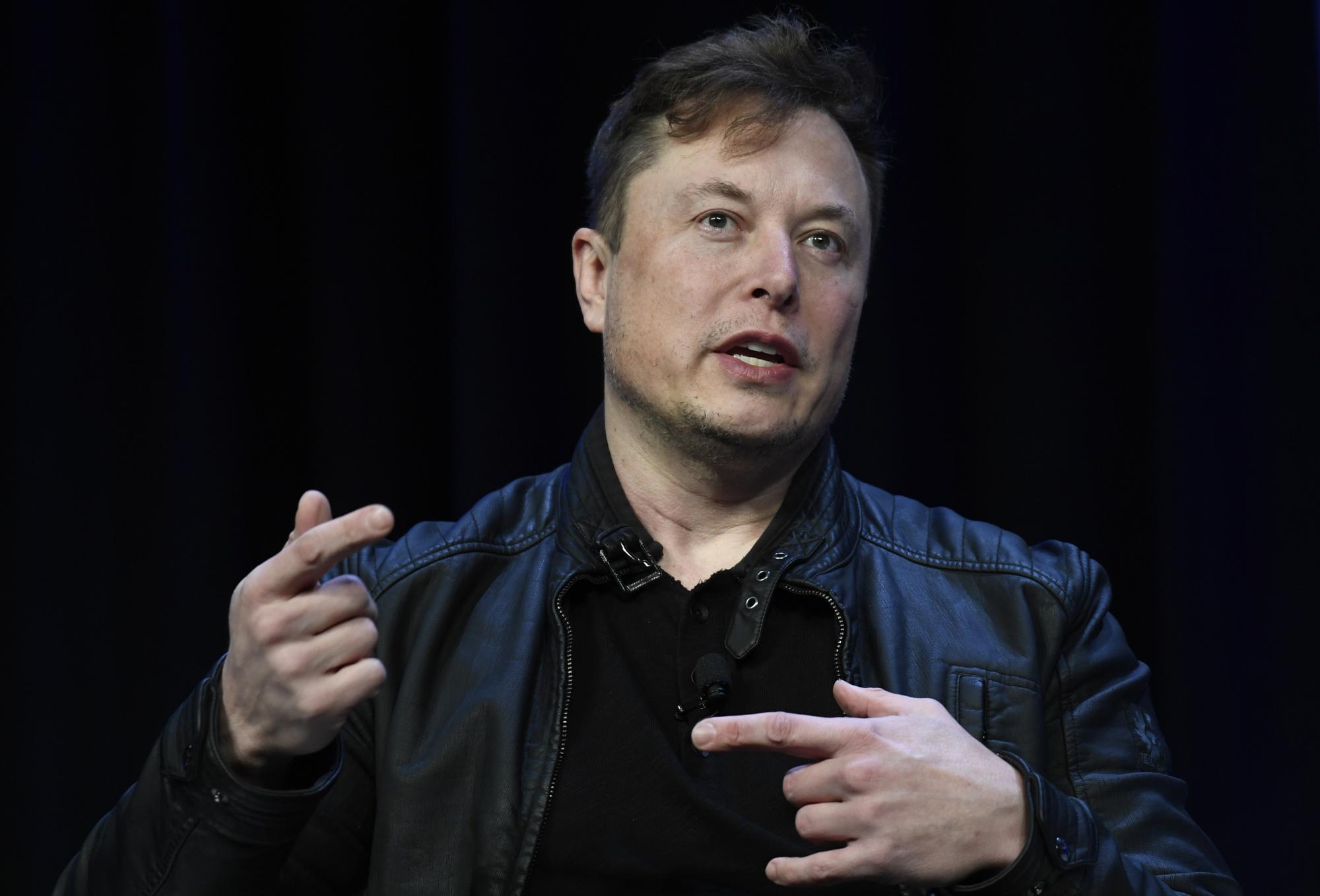 Elon Musk wearing a leather jacket