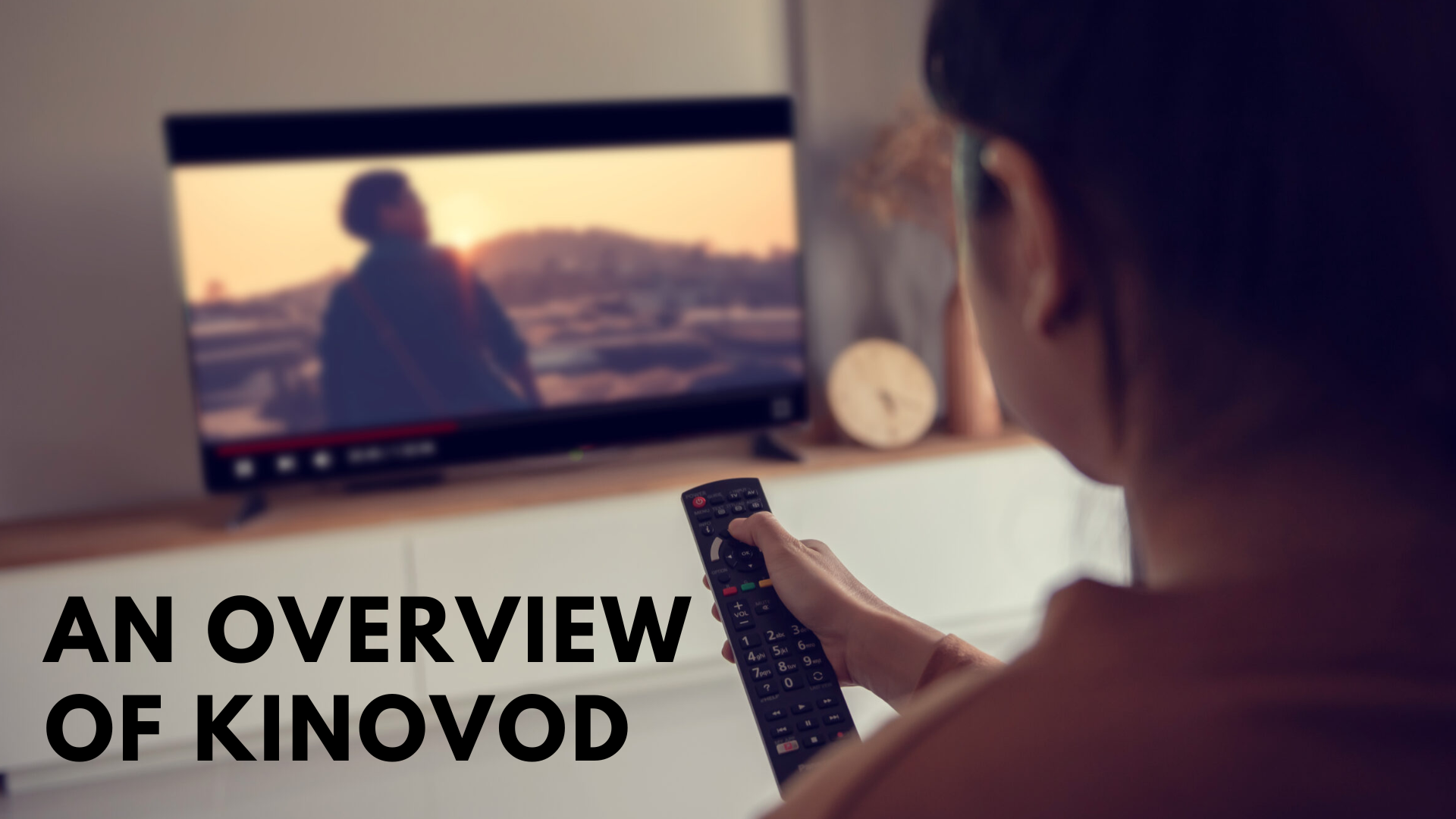 A woman holding a remote and watching movie