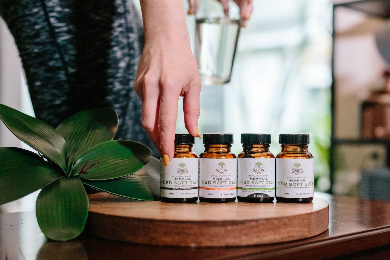 Four Essential Oil Bottles On A Wooden Table