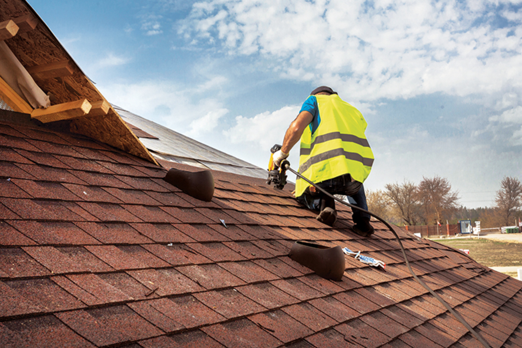 A professional roofer making repairs