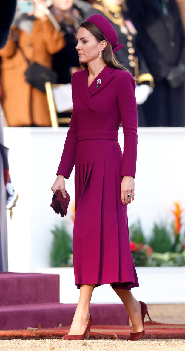 Kate Middleton in a Magenta dress and a hat attending an event