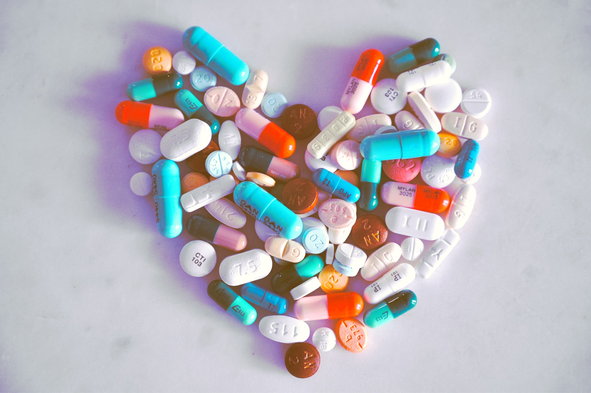 A bunch of different pills shaped into a heart