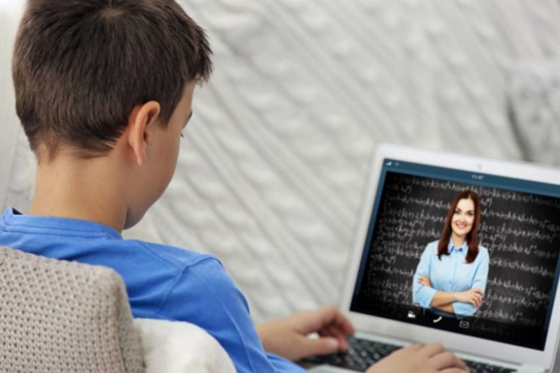 A child studying on a laptop with an online tutor teacher