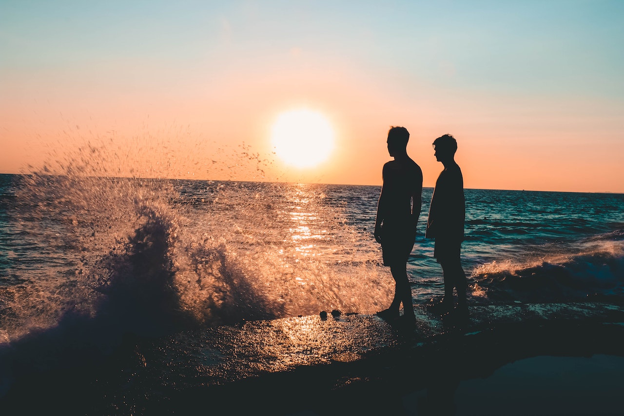 Two Men Standing on Seashore