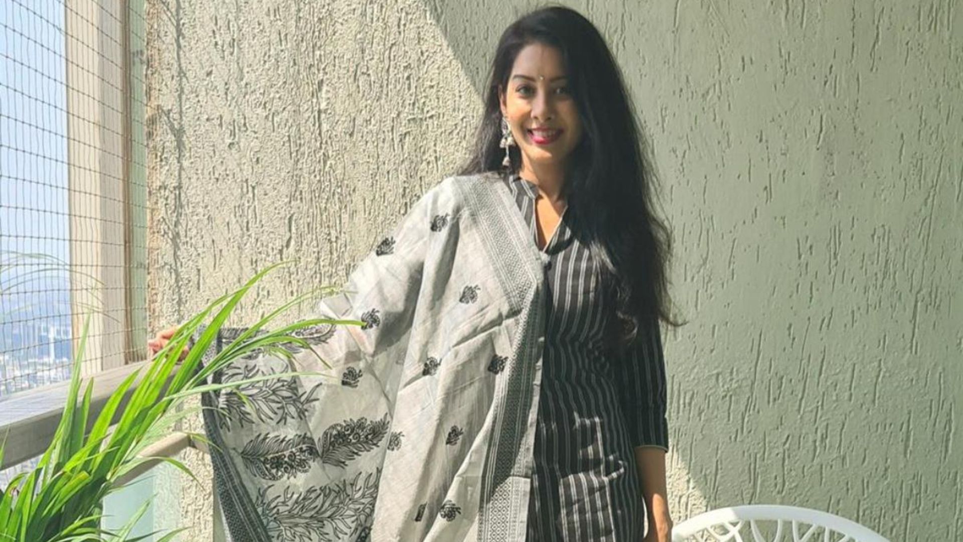 Simran Khanna In Black Striped Dress Standing In Balcony