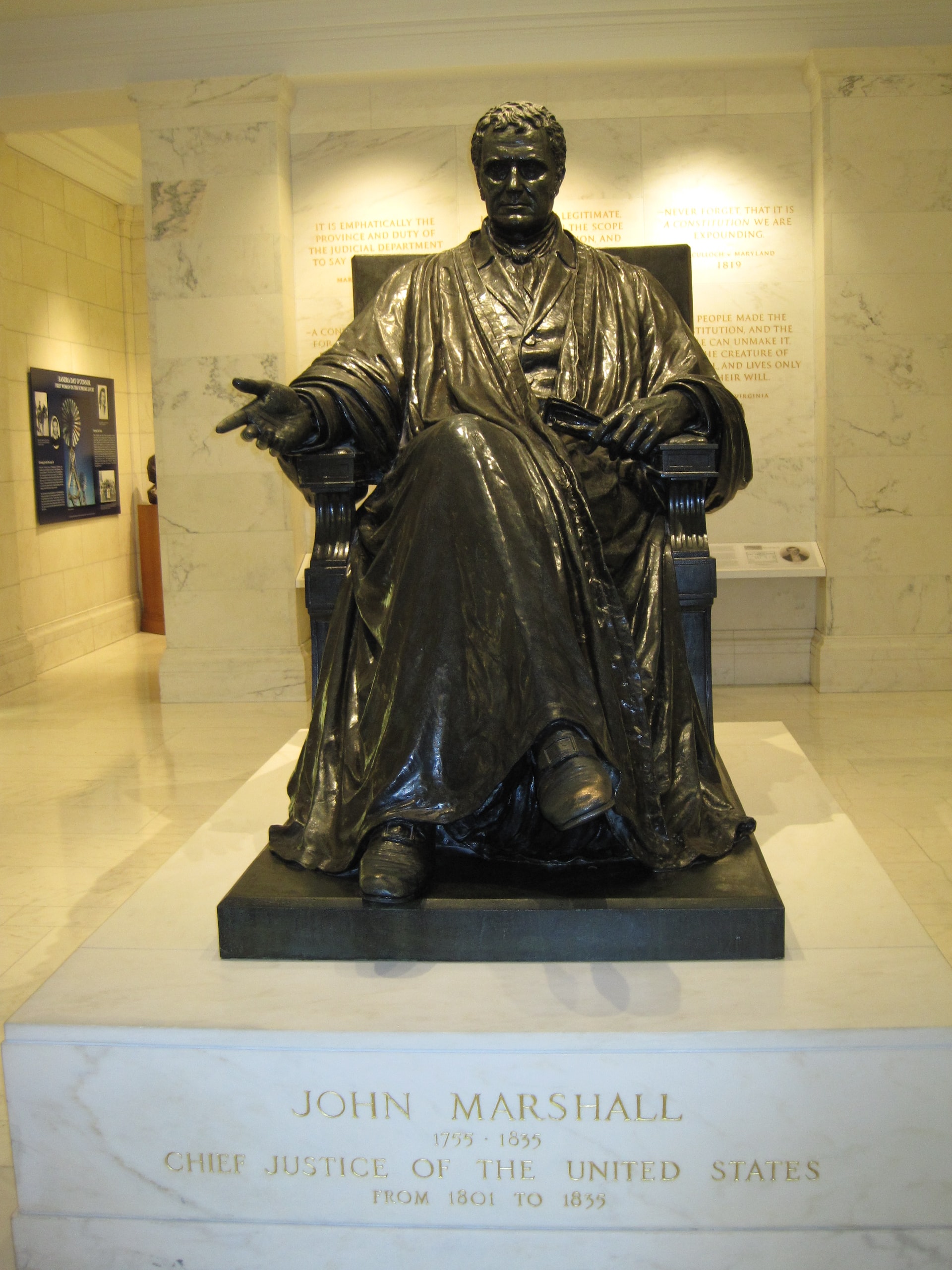 Statue of a seated Chief Justice John Marshall inside the U.S. Supreme Court building in Washington, D.C.