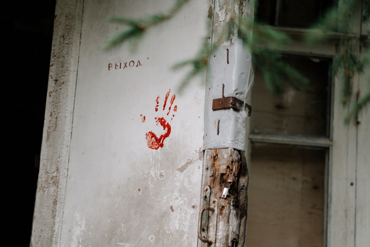 Blood Stained Hand on Wooden Door