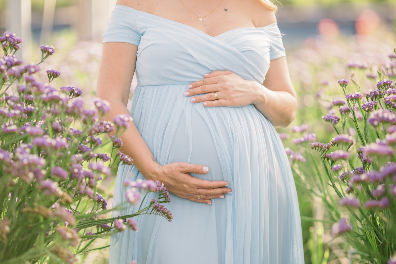 A Pregnant Woman In A Blue Dress