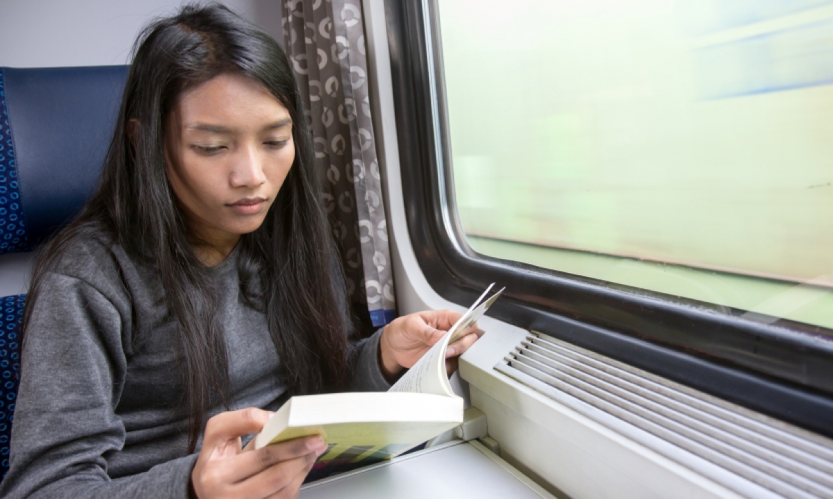 A woman reading while on travel