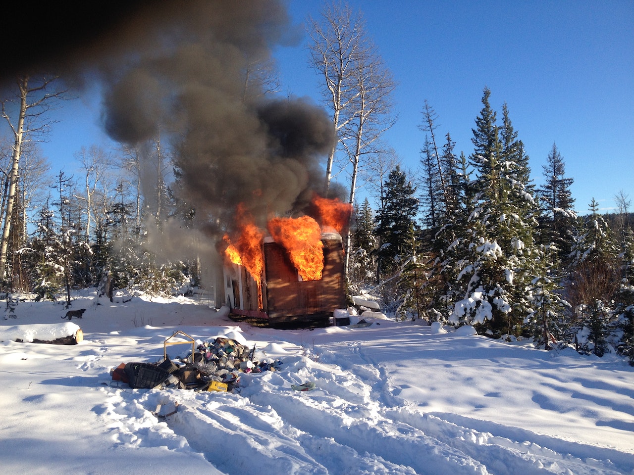Burning House In Woods In Snowy Area