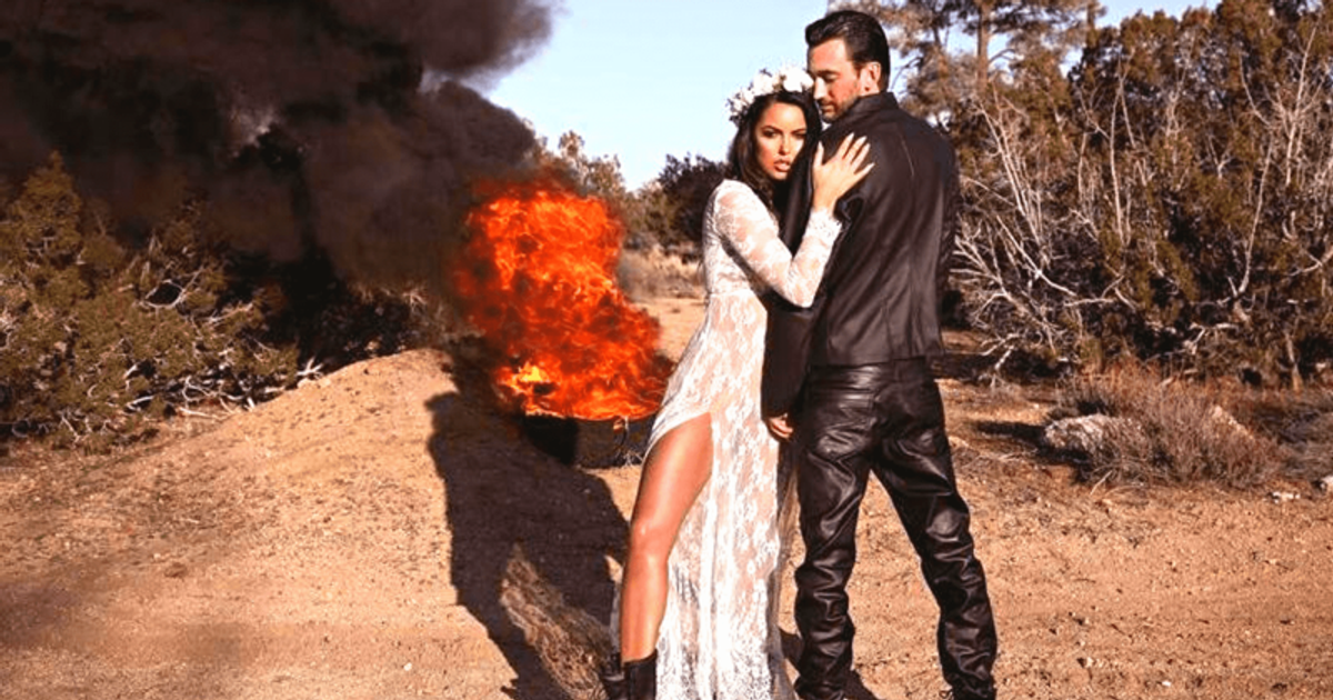 Jared Toller and his wife Constance Nunes posing for a picture with fire behind them