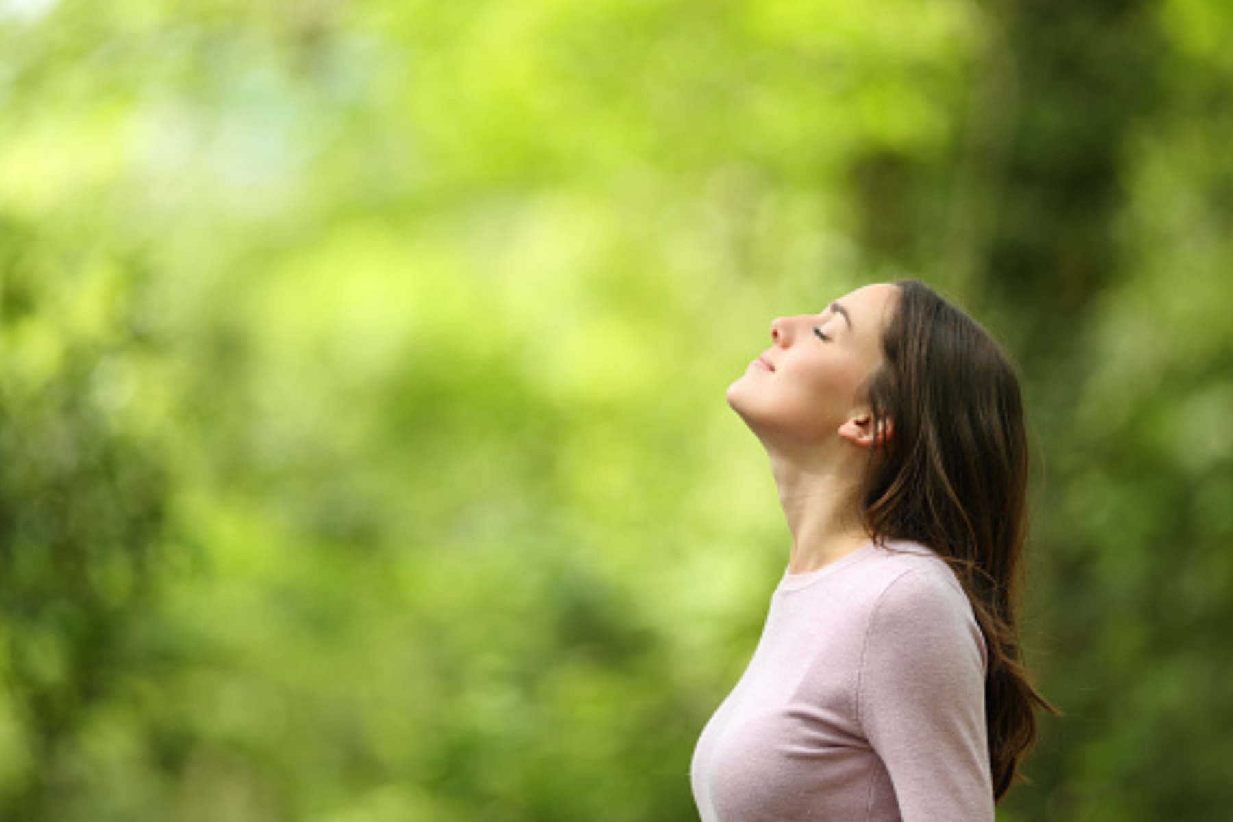 A woman relaxing and breathing in nature