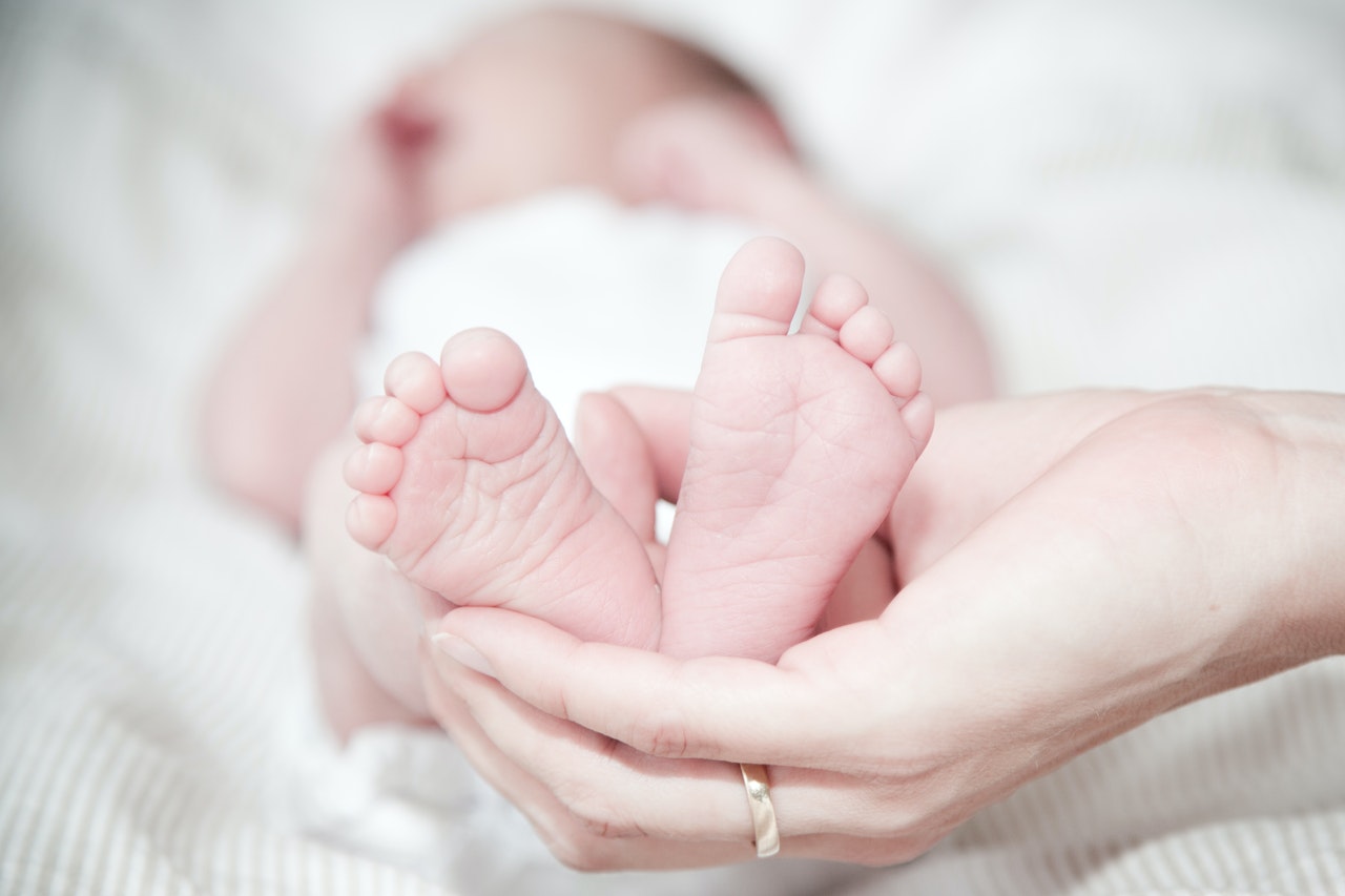 Hand Holding Newborn Baby's Feet