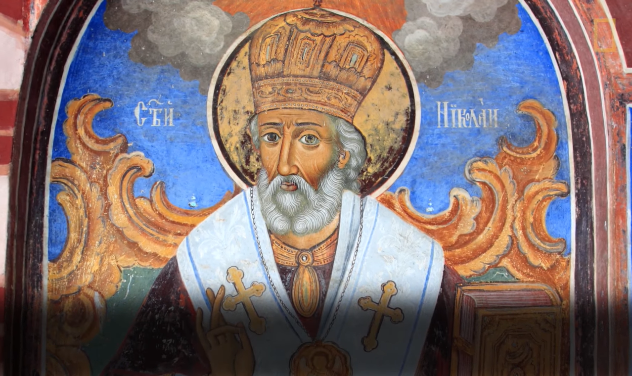 Saint Nicholas with white hair and beard covering his neck in liturgical vestment and a miter on his head