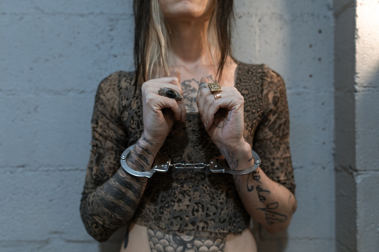 A Woman with Tattoo in Handcuffs