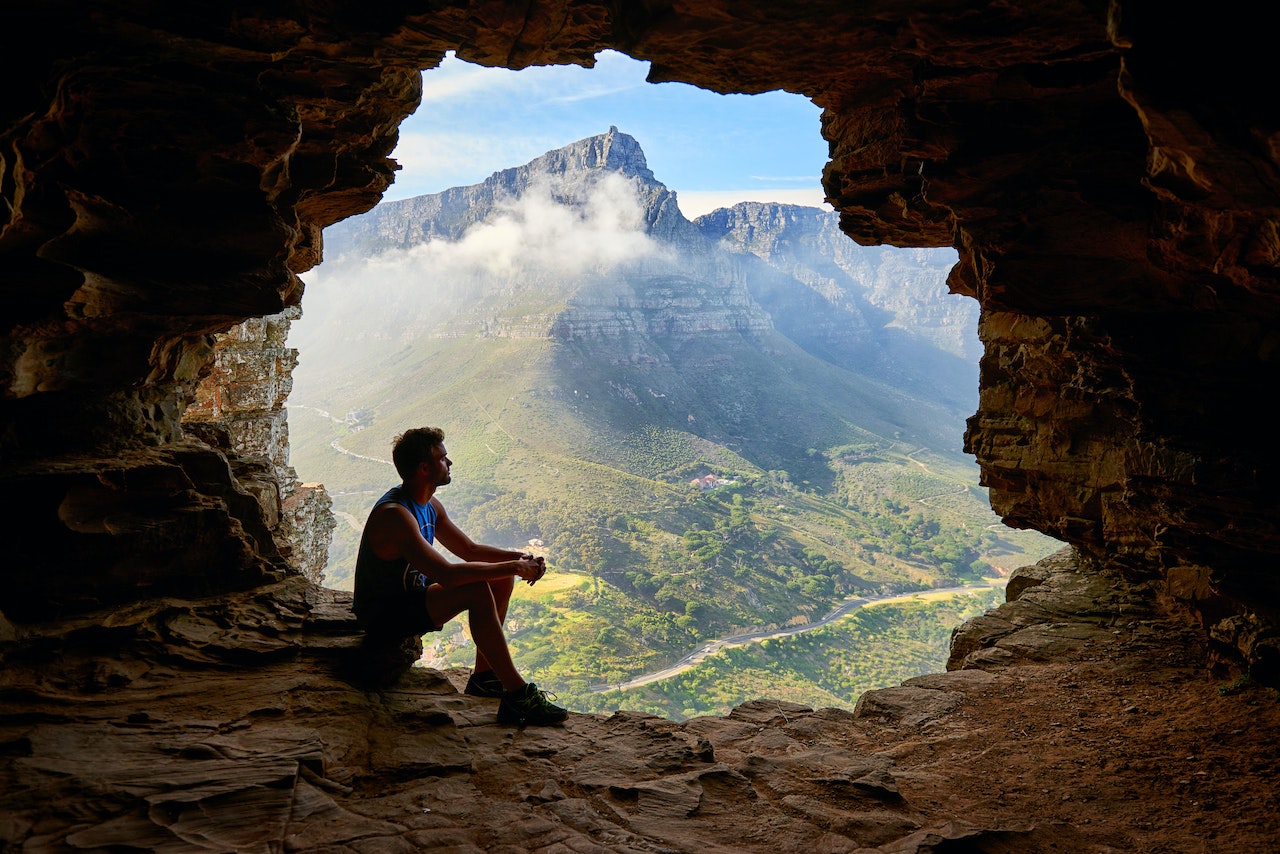  Man Sitting on a Cave