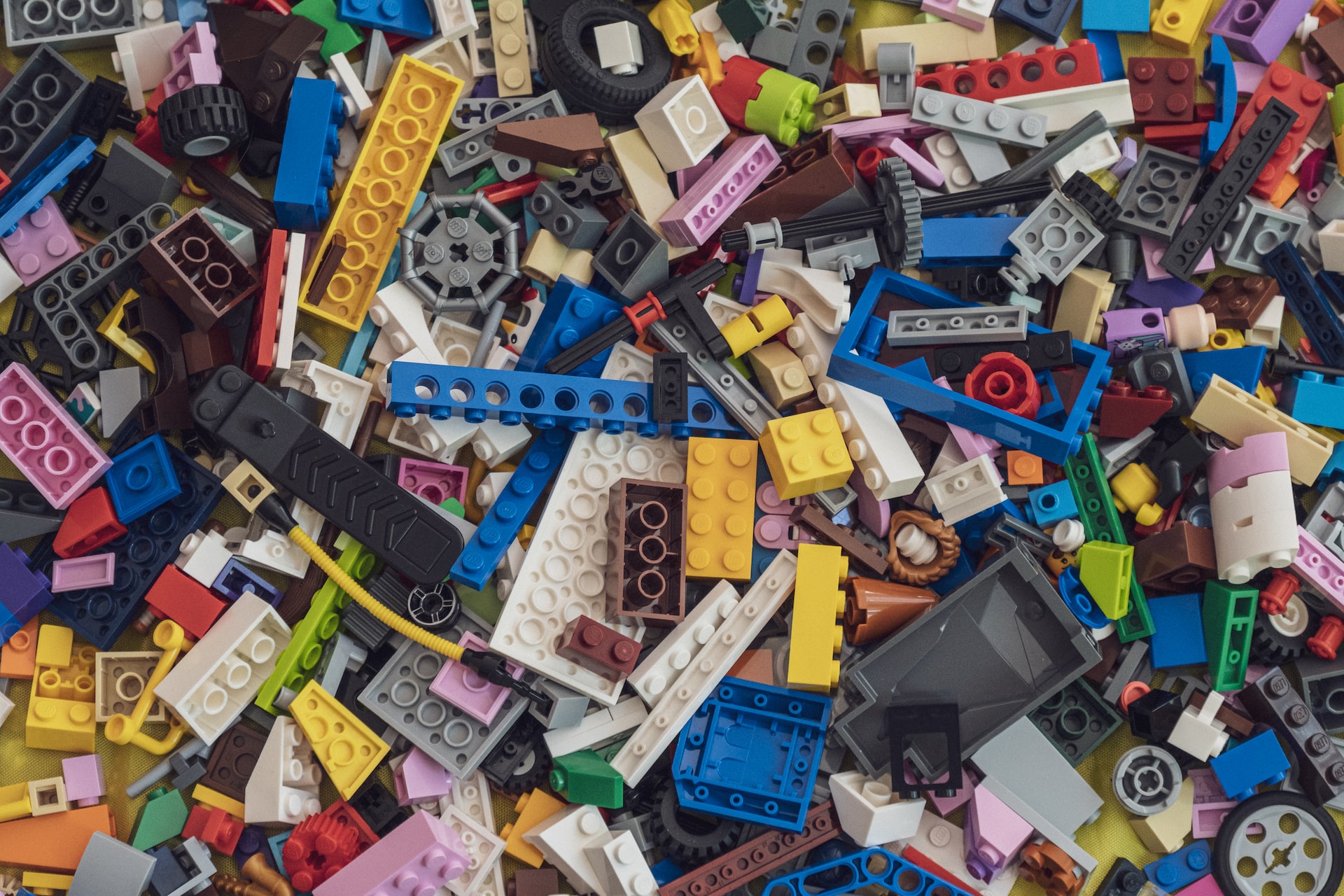 A pile of assorted LEGO pieces in different shapes and colors