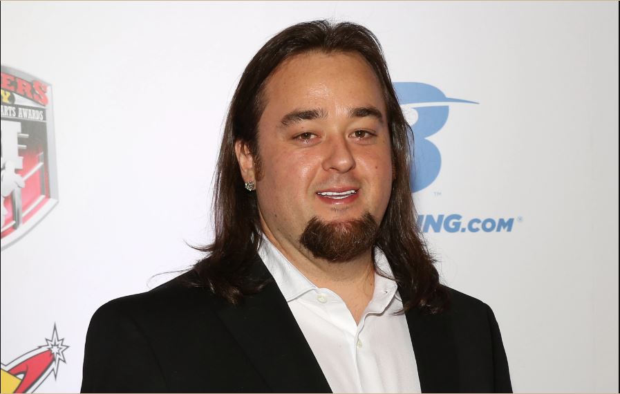 Chumlee wearing a black suit and white shirt at an event