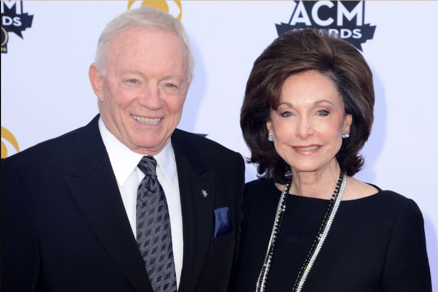 Eugenia Jones wearing a black gown with her husband, Jerry Jones, wearing a black suit