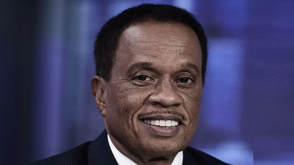 Susan Delise's husband Juan Williams wearing a black suit with a big smile on his face