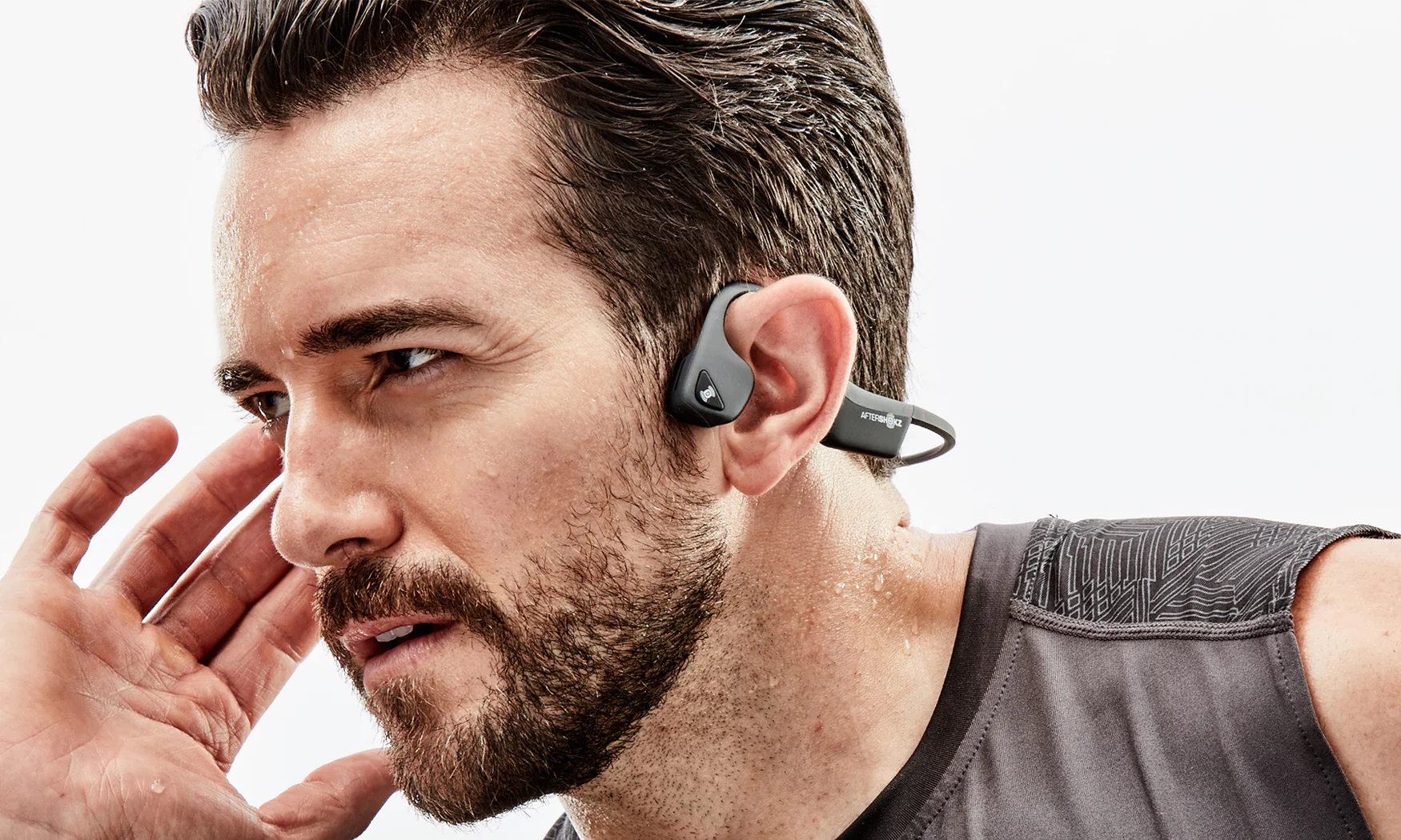 A man wearing AfterShokz Trekz Air bone conduction headphones